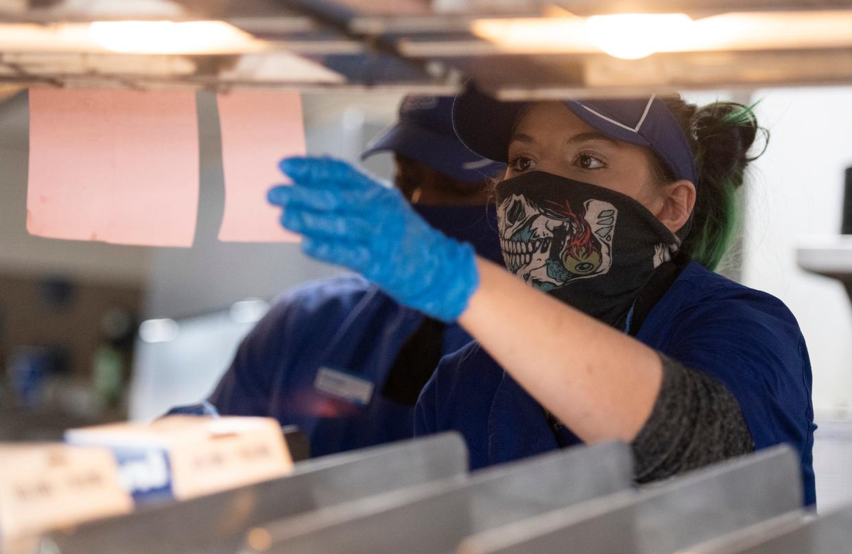 An employee checks an order in the kitchen at Culver's in Fort Collins in this file photo. The city is considering whether to raise the minimum wage from $12.56 hourly to $15.