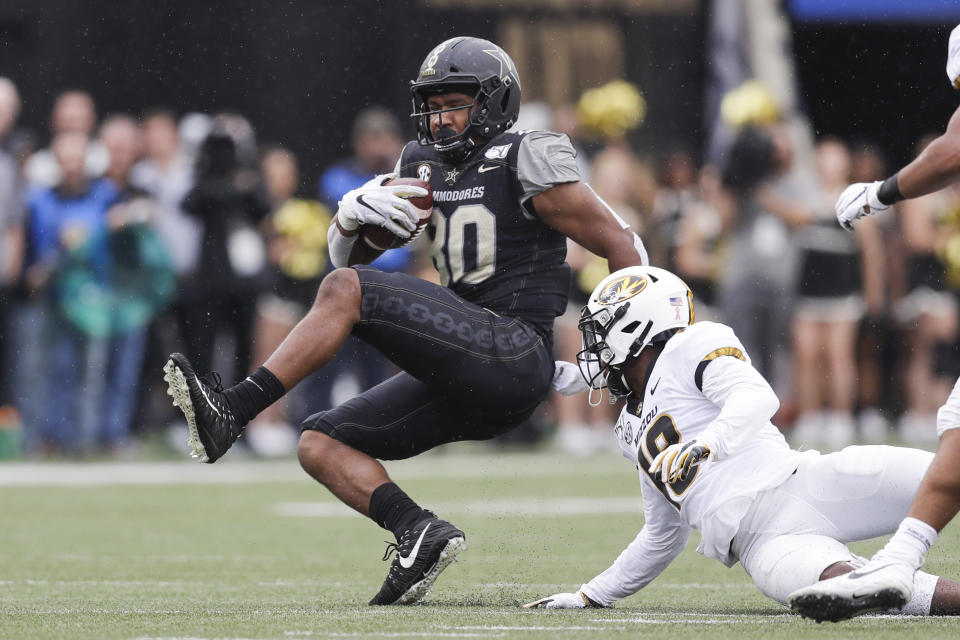 Vanderbilt tight end Jared Pinkney (80) is brought down by Missouri safety Joshuah Bledsoe (18) in the first half of an NCAA college football game Saturday, Oct. 19, 2019, in Nashville, Tenn. (AP Photo/Mark Humphrey)