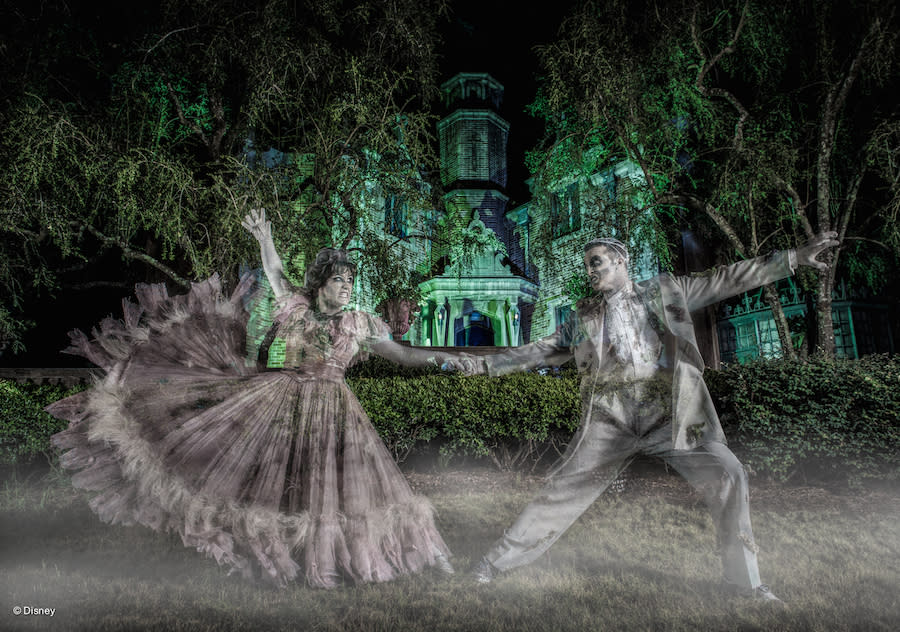 Ghost couple dances at night in a still from Disney'sHaunted Mansion. 