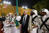 US President Donald Trump joins dancers with swords at a welcome ceremony ahead of a banquet at the Murabba Palace in Riyadh on May 20, 2017