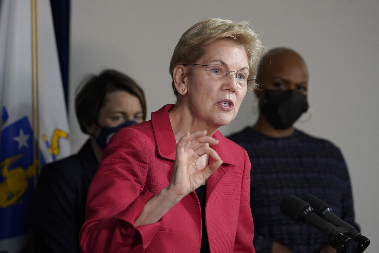 U.S. Sen. Elizabeth Warren, D-Mass., center, responds to questions from reporters as Mass. Attorney General Maura Healey, left, and U.S. Rep. Ayanna Pressley, D-Mass., right, look on during a news conference Thursday, April 1, 2021, in Boston. The news conference was held to call on President Biden to use the Higher Education Act to cancel a share of student loan debt for students with federal loans. (AP Photo/Steven Senne)