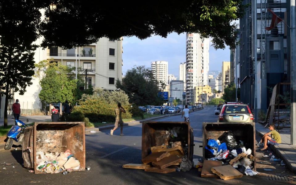 Anti-government protesters block a road with waste containers during a protest to demand a change of the sectarian system and finding solutions to the daily-living and economic crisis - WAEL HAMZEH/EPA-EFE/Shutterstock /Shutterstock