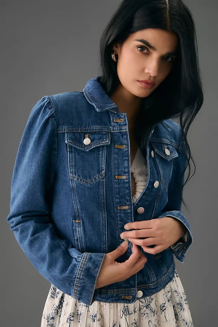 woman wears blue Pilcro Puff-Sleeve Denim Jacket Anthropologie.