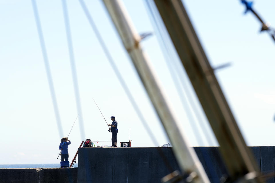 Anglers prepare to fish at Numanouchi port, Iwaki, northeastern Japan, near the Fukushima Daiichi nuclear power plant, damaged by a massive March 11, 2011, earthquake and tsunami, on Friday, Aug. 25, 2023. The Fukushima Daiichi nuclear power plant started releasing treated and diluted radioactive wastewater into the Pacific Ocean on Thursday. (AP Photo/Eugene Hoshiko)