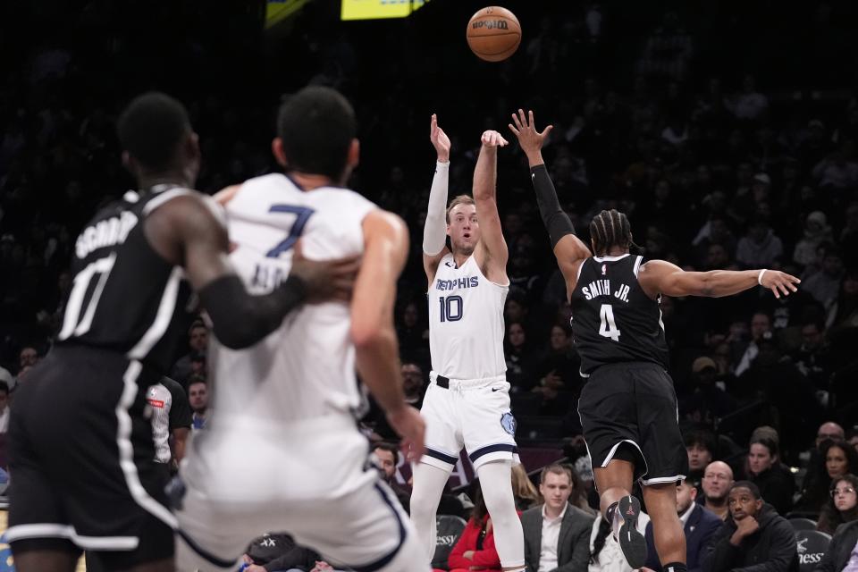 Memphis Grizzlies' Luke Kennard (10) shoots a 3-point basket over Brooklyn Nets' Dennis Smith Jr. (4) during the second half of an NBA basketball game Monday, March 4, 2024, in New York. (AP Photo/Frank Franklin II)
