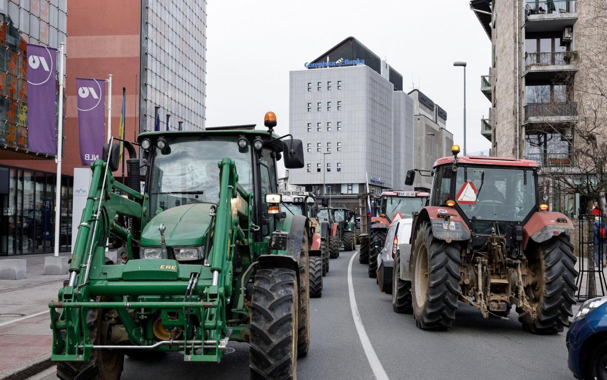 Farmers drive their tractors through the city of Kranj, Slovenia, in protest against EU green laws - Shutterstock