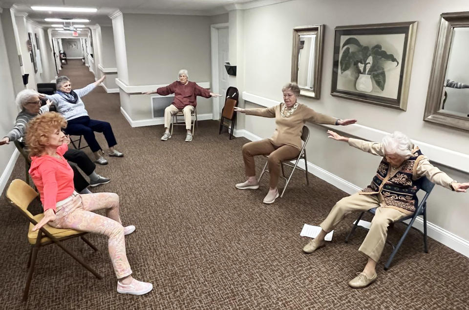 Bailey, seated first on the right, goes through exercises designed to move all parts of the body. (Courtesy Elk Ridge Village Senior Living)