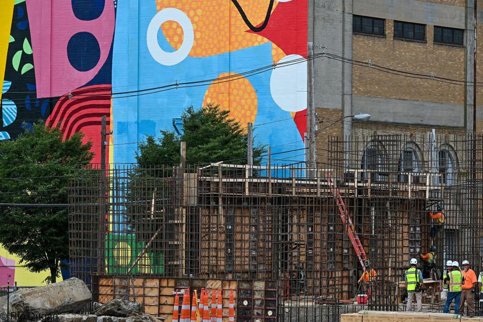 The Mural of Unusual Size is seen Friday across West Baltimore Street as construction is underway at the future Hagerstown Multi-Use Sports and Events Facility. The nearly $70 million structure is expected to open next spring in time for the start of the season for Hagerstown's new Atlantic League of Professional Baseball team.