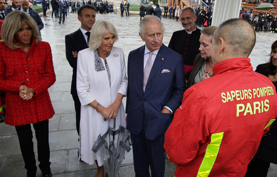 Britain's King Charles III, Queen Camilla and French President Emmanuel Macron, second left, and his wife Brigitte Macron, left, meet firefighters during a visit on the Notre-Dame Cathedral rebuilding site in Paris, Thursday, Sept, 21 2023. On the second day of his state visit to France, King Charles met with sports groups in the northern suburbs of Paris and pays a visit to fire-damaged Notre-Dame cathedral. (Christophe Petit Tesson, Pool via AP)