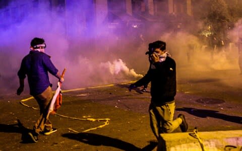 Protesters flee gas grenades in Beirut  - Credit: REX