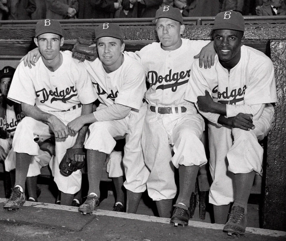 FILE - From left, Brooklyn Dodgers third baseman John Jorgensen, shortstop Pee Wee Reese, second baseman Ed Stanky, and first baseman Jackie Robinson pose before a baseball game against the Boston Braves at Ebbets Field in Brooklyn, N.Y., in this April 15, 1947, file photo. All players, managers, coaches and umpires will wear No. 42 on Thursday, April 15, 2021, to celebrate Jackie Robinson Day, marking the anniversary of the date the Brooklyn Dodgers Hall of Famer made his Major League Baseball debut and broke the sport's color barrier in 1947. (AP Photo/Harry Harris, File)