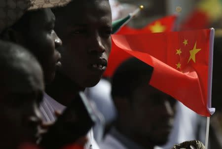 Well wishers holding flags wait for the arrival of Chinese President Xi Jinping at the Leopold Sedar Senghor International Airport at the start of his visit to Dakar, Senegal July 21, 2018. REUTERS/Mikal McAllister