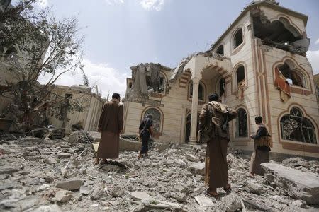 Guards walk on the rubble of the house of Brigadier Khaled al-Anduli, an army commander loyal to the Houthi movement, after it was hit by Saudi-led air strikes in Yemen's capital Sanaa July 6, 2015. REUTERS/Khaled Abdullah