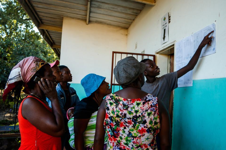 People gather a day after elections to look at results posted outside a polling station in Harare, Zimbabwe on July 31 2018.