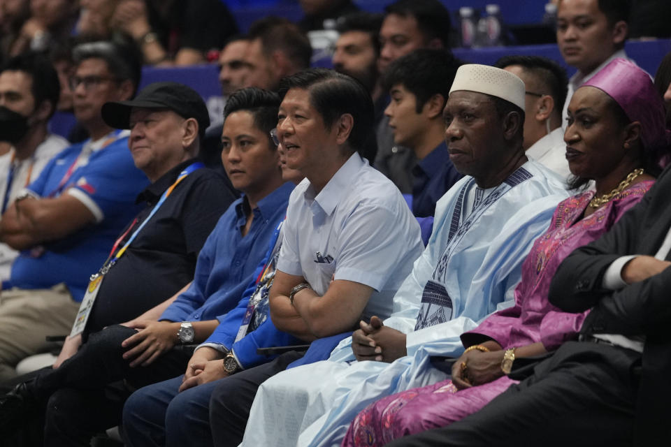 Philippine President Ferdinand Marcos Jr., center, watches the game beside FIBA president Hamane Niang, second from right, during a match of the Philippines against Dominican Republic at the Basketball World Cup at the Philippine Arena in Bulacan province, Philippines Friday, Aug. 25, 2023. (AP Photo/Aaron Favila)