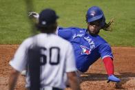 New York Yankees' Asher Wojciechowski (60) watches as Toronto Blue Jays' Vladimir Guerrero Jr. scores on Jonathan Davis single during the third inning of a spring baseball game Sunday, Feb. 28, 2021, in Tampa, Fla. (AP Photo/Frank Franklin II)