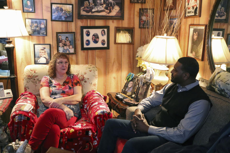 Rosa Runyon, left, speaks to Environmental Protection Agency Administrator Michael Regan about living without access to safe drinking water during a visit to her home in Premier, W.Va., on Tuesday, Dec. 6, 2022. (AP Photo/Leah Willingham)