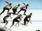 Michel Mulder of the Netherlands (top) and Japan's Keiichiro Nagashima skate during the men's 500 metres speed skating race at the Adler Arena during the 2014 Sochi Winter Olympics February 10, 2014. Picture taken with in camera multiple exposure mode. REUTERS/Marko Djurica