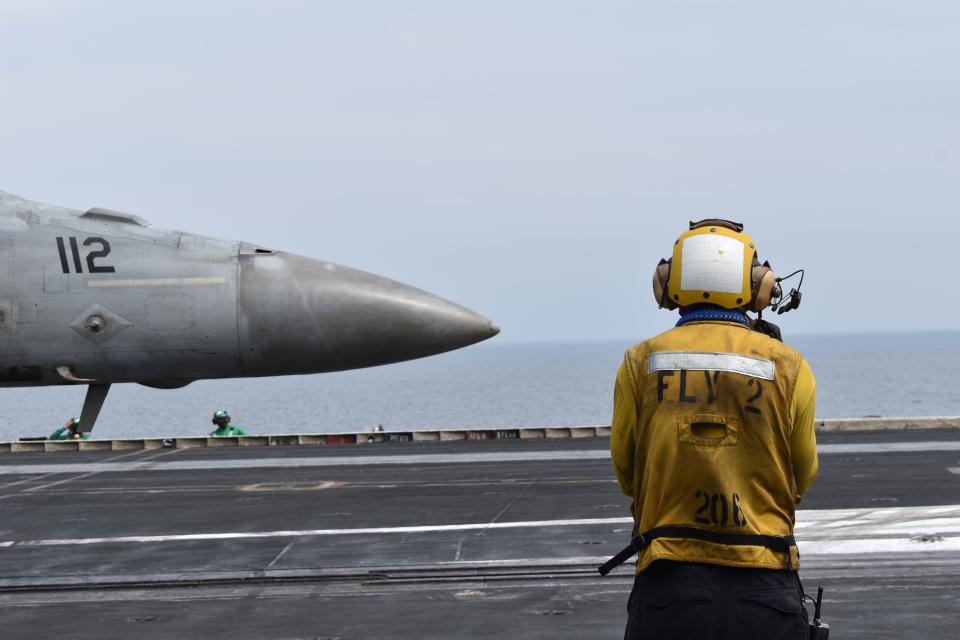 A fighter jet prepares for take off on the USS Dwight D. Eisenhower.