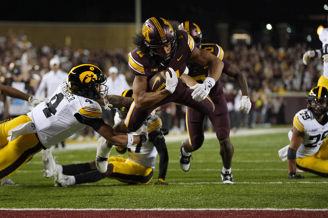 Minnesota wide receiver Elijah Spencer (11) dives to score an 11-yard touchdown during the first half of an NCAA college football game against Iowa, Saturday, Sept. 21, 2024, in Minneapolis. (AP Photo/Abbie Parr)