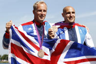 Bronze medallists Britain's Liam Heath (R) and Jon Schofield stand on the podium during the victory ceremony for the men's kayak double (K2) 200m final at the Eton Dorney during the London 2012 Olympic Games August 11, 2012. REUTERS/Jim Young (BRITAIN - Tags: OLYMPICS SPORT CANOEING) 