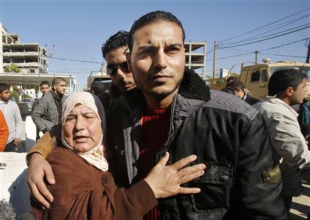 A Palestinian woman hugs her son upon his release from a Hamas-run jail in Gaza City January 8, 2014. REUTERS/Suhaib Salem