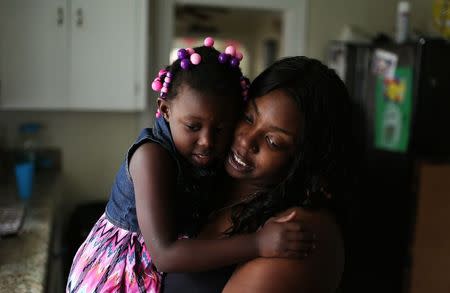 Shala Cooper-Bowser is pictured with her daughter Damyiah at her home in Richmond, Virginia, U.S. June 25, 2016. Cooper-Bowser's infant son Josiah Cooper-Pope died after contracting MRSA during an out break in a Richmond neonatal intensive care unit. Picture taken June 25, 2016. REUTERS/Chet Strange