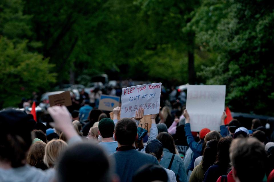 Demonstrators march to the house of Supreme Court Justice Samuel Alito in Alexandria, Virginia, on Monday.