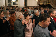 Audience members applaud the Shchedryk youth choir following a Christmas concert at Copenhagen’s Church of the Holy Spirit, in Copenhagen, Denmark, Thursday, Dec. 8 2022. The Shchedryk ensemble, described as Kyiv’s oldest professional children’s choir, were in the Danish capital this week for a performance as part of an international tour that also took them to New York’s famed Carnegie Hall. (AP Photo/James Brooks)