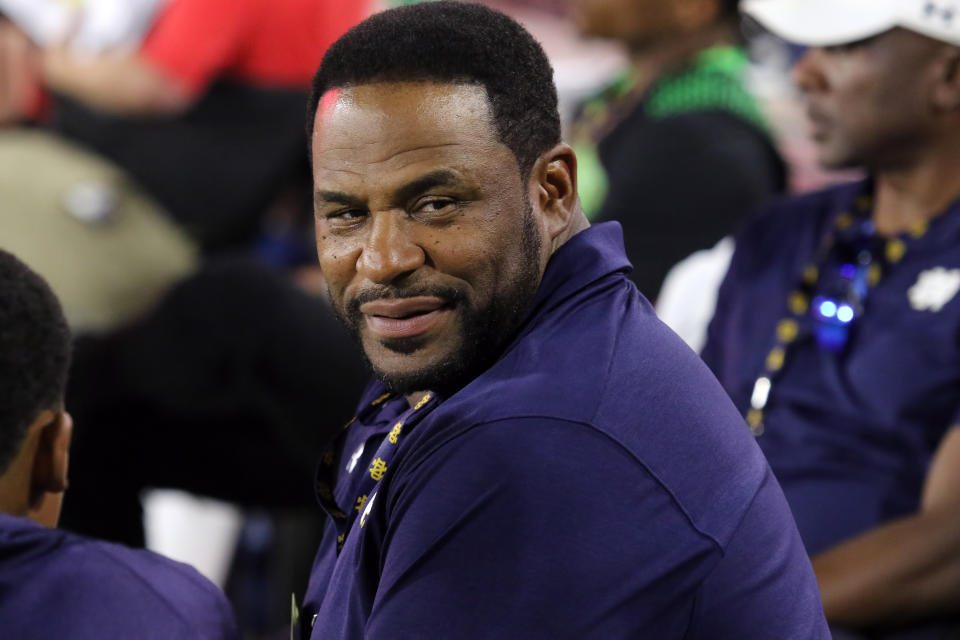 Jerome Bettis looks to his left over his shoulder with a slight smile.