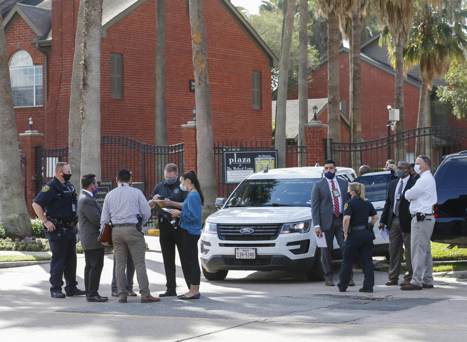 Law enforcement officials work on the scene of a shooting at an apartment complex Tuesday, Oct. 20, 2020, in Houston. Two Houston officers were shot before a SWAT team was dispatched to the scene, where the suspected shooter was arrested, authorities said. (Godofredo A. Vásquez / Houston Chronicle via AP)