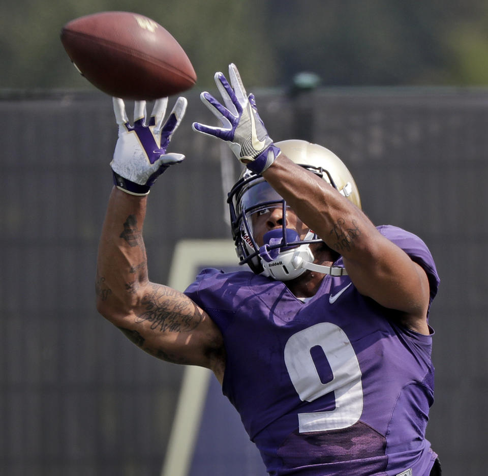 FILE - In this Aug. 10, 2018, file photo, Washington's Myles Gaskin reaches for a pass reception at NCAA college football practice, in Seattle. No. 6 Washington's potential Heisman Trophy contenders Gaskin and quarterback Jake Browning play against No. 9 Auburn in the only opening-week game between top ten teams. (AP Photo/Elaine Thompson, File)