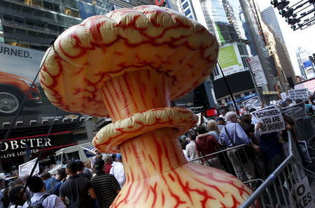 An inflatable mushroom cloud stands among demonstrators during a rally apposing the nuclear deal with Iran in Times Square in the Manhattan borough of New York City, July 22, 2015. REUTERS/Mike Segar