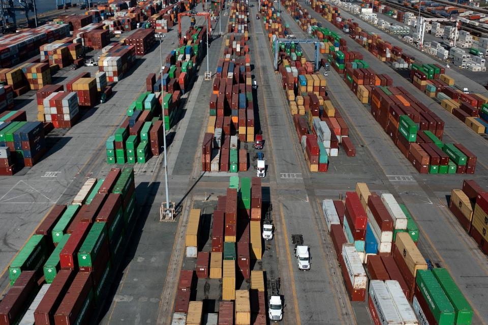 In this aerial image, cargo containers are readied for transport at the Port of Baltimore in Baltimore, Maryland, on October 14, 2021. - Closed factories, clogged ports, no truck drivers -- up and down the global supply chain there are problems, raising concerns that it could disrupt the global economic recovery. (Photo by Brendan Smialowski / AFP) (Photo by BRENDAN SMIALOWSKI/AFP via Getty Images)