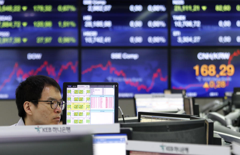 A currency trader watches monitors at the foreign exchange dealing room of the KEB Hana Bank headquarters in Seoul, South Korea, Wednesday, June 26, 2019. Asian shares were mostly lower Wednesday as investors awaited developments on the trade friction between the U.S. and China at the Group of 20 meeting of major economies in Japan later in the week. (AP Photo/Ahn Young-joon)