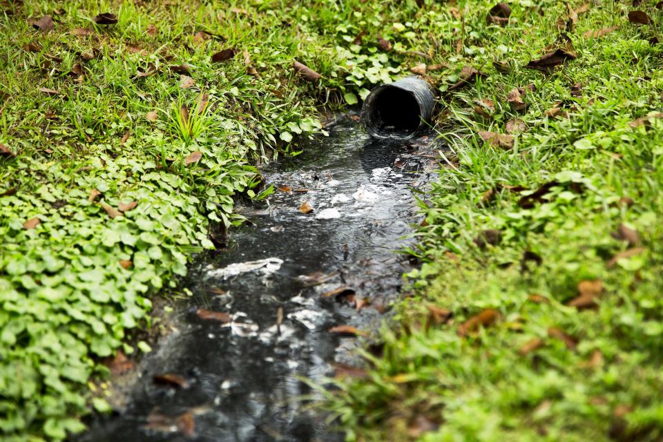 An open sewer runs through the backyard of a grouping of trailers in a community on the border of Lowndes County. (Photo: ANNA LEAH FOR HUFFPOST)