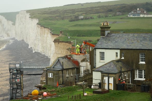A general view of the cottage at Birling Gap near Eastbourne, East Sussex, as work continues to demolish the property due to the continuing erosion of the cliff edge. PRESS ASSOCIATION Photo. Picture date: Monday April 7, 2014. Photo credit should read: Gareth Fuller/PA Wire