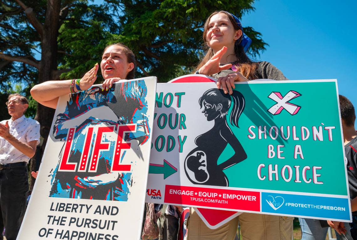 Sisters Isabella Carreiro, 24, left, and Raquel Carreiro, 21, of Harvest Valley Church in Pleasanton, cheer a speaker during the California March for Life rally at the state Capitol on Monday.