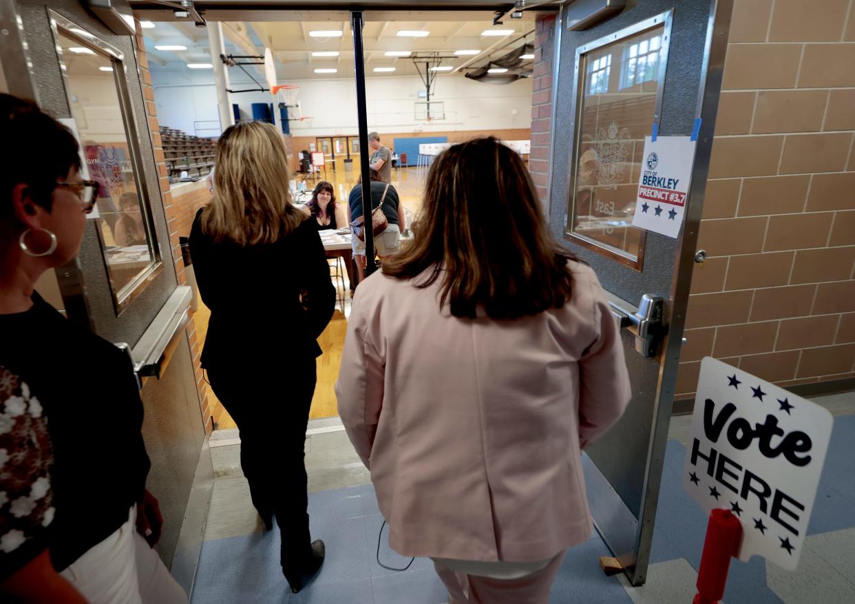Michigan Secretary of State Jocelyn Benson heads inside the auxiliary gymnasium on Election Day at Berkley High School to meet poll workers on Tuesday, August 8, 2023. 
