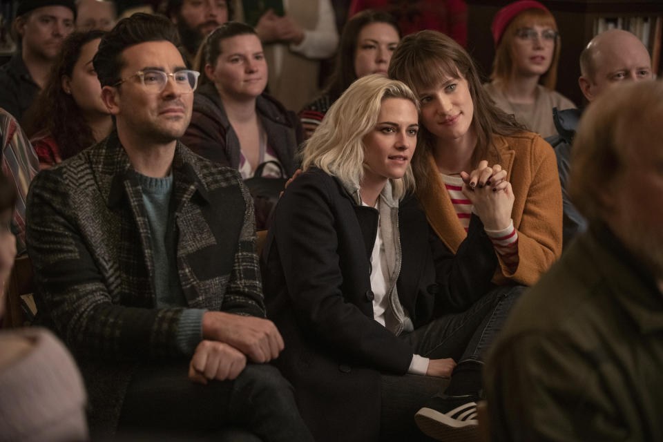 This image released by Hulu shows Dan Levy, from left, Kristen Stewart, and Mackenzie Davis in a scene from "Happiest Season." (Lacey Terrell/Hulu via AP)