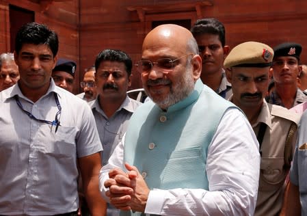 FILE PHOTO: India's newly appointed Home Minister Amit Shah greets the media upon his arrival at the home ministry in New Delhi