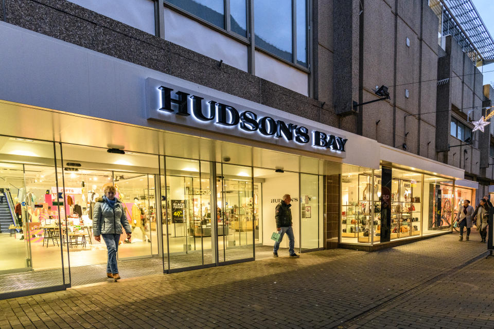 Hudson's Bay Company retail store in Zwolle during a cold winter evening. People are walking on the street and looking at the shop windows.