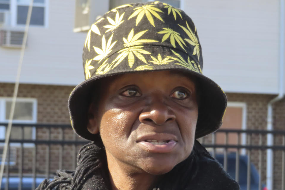 Delorese Butley-Whaley speaks in the parking lot of a housing complex in Atlantic City N.J. on Friday, Dec. 8, 2023 where a specially modified bus that serves as a mobile supermarket had just arrived. Virtua Health and the New Jersey Economic Development Authority are operating a service to bring fresh groceries and produce to Atlantic City, where plans for what would be the city's first supermarket in nearly 20 years recently fell through. (AP Photo/Wayne Parry)