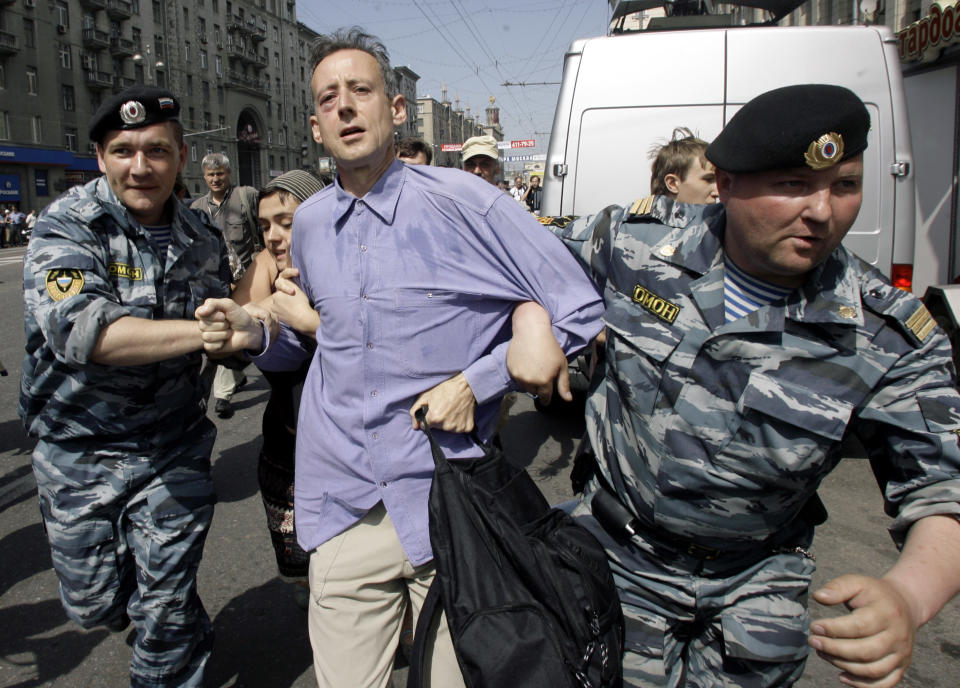 FILE - In this Sunday, May 27, 2007 file photo, riot police officers detain British human rights activist Peter Tatchell as gay rights activists try to hold a demonstration in downtown Moscow. Tatchell says he has been meeting frequently with the London Olympic organizers to seek an extensive gay and transgender role in the games, and described the results thus far as "a huge disappointment." "The only things that have happened have been the pin badges and the recruitment of LGBT volunteers," he said. (AP Photo/Sergey Ponomarev)