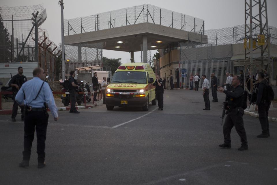 An ambulance leaves the Sharon Prison while Israeli police SWAT team entered the prison, near Raanana, central Israel, Sunday, Feb. 23, 2014. Israeli police say a SWAT team has killed an inmate who had seized a guard's weapon and shot three guards. Police spokesman Micky Rosenfeld said Sunday that the inmate, who was serving a long sentence for murder, had barricaded himself after shooting the guards. A standoff ensued, with counter-terrorism units dispatched to the scene. The inmate then opened fire again, he said, before the forces shot him dead. Of the three guards shot, two were seriously wounded, third was lightly wounded. The prisoner was not officially identified, but Israeli media reports identified him as Samuel Sheinbein, an American who fled to Israel after committing a murder in Maryland in 1997. (AP Photo/Ariel Schalit)