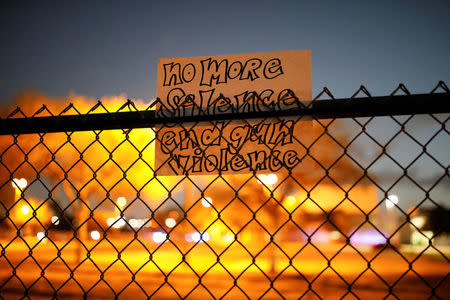 A note is seen on the fence of the Marjory Stoneman Douglas High School following a mass shooting, in Parkland, Florida, U.S., February 21, 2018. REUTERS/Carlos Garcia Rawlins