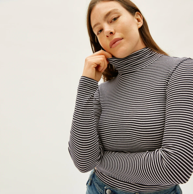 The Pima Micro-Rib Turtleneck in Black / Bone. Image via Everlane.