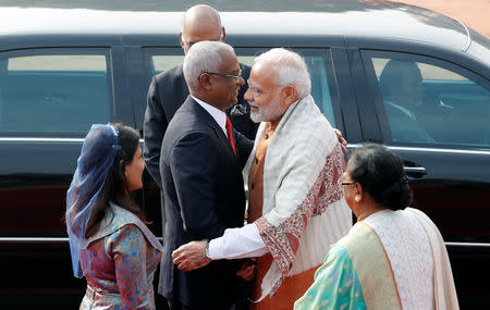 India's Prime Minister Narendra Modi hugs Maldives President Ibrahim Mohamed Solih (2nd L) as Solih's wife Fazna Ahmed (L) and Savita Kovind (R), wife of Indian President Ramnath Kovind's, looks on during Solih’s ceremonial reception in New Delhi, December 17, 2018. REUTERS/Adnan Abidi