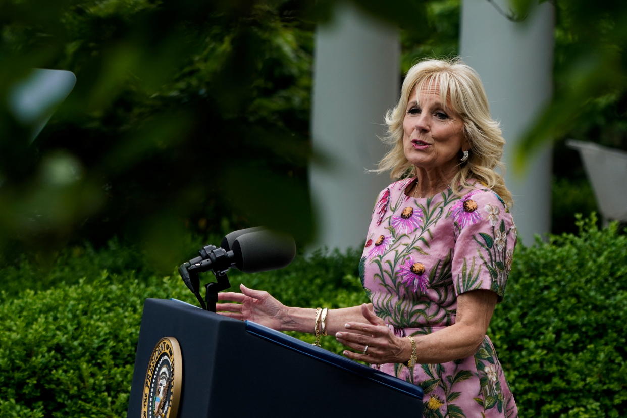 Jill Biden stands at a podium as she speaks at the White House Rose Garden.