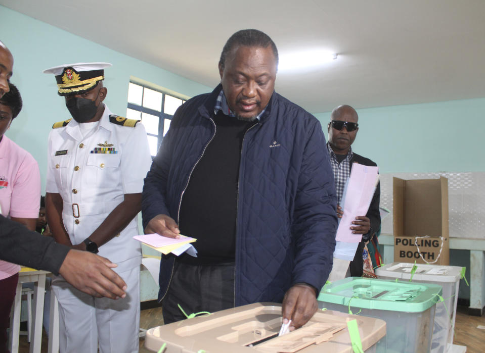 Kenya President Uhuru Kenyatta casts his vote at Mutomo Primary School, Gatundu, Central Kenya Tuesday Aug. 9, 2022, with leading candidates Raila.Odinga and William Ruto vying to become the new president of East Africa's economic hub. (AP Photo)